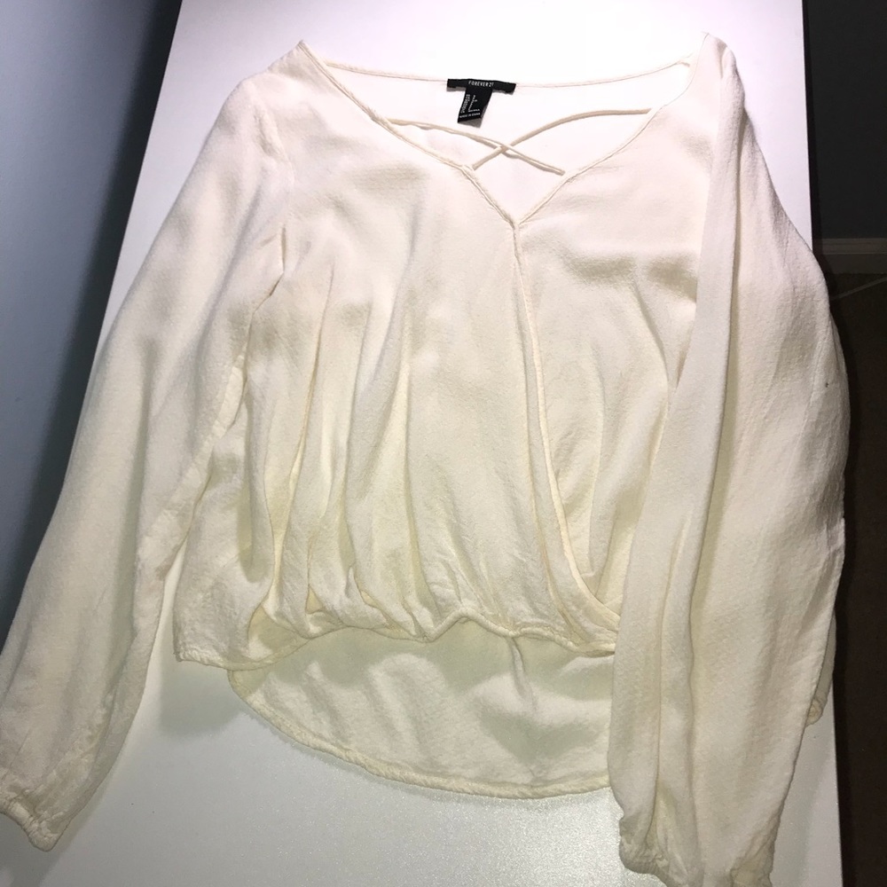 A cream white long sleeve v-neck blouse